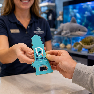 Aquarium Gift Shop custom logo bottle opener magnet - handed to a customer