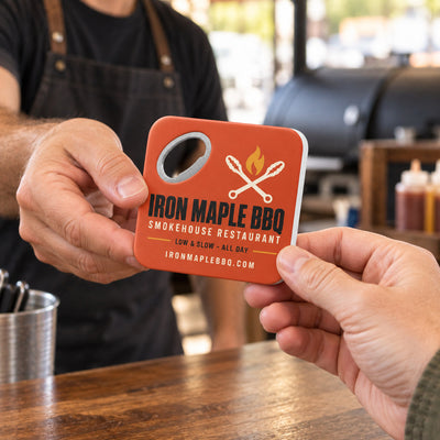 Barbecue Restaurant custom logo bottle opener magnet - handed to a customer