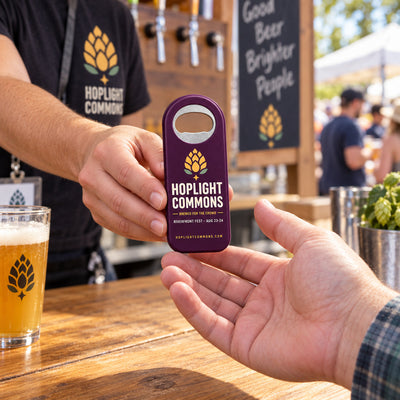 Beer Festival custom logo bottle opener magnet - handed to a customer