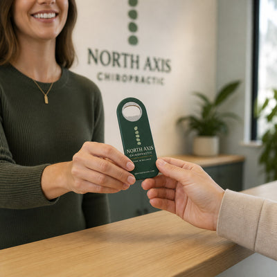 Chiropractic Clinic custom logo bottle opener magnet - handed to a customer
