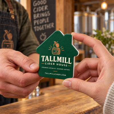 Cider House custom logo bottle opener magnet - handed to a customer