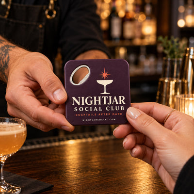 Cocktail Bar custom logo bottle opener magnet - handed to a customer