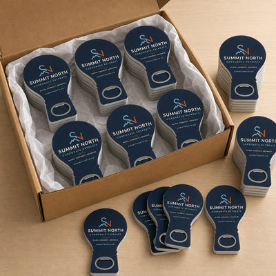 Corporate Retreat custom logo bottle opener magnet - bulk order laid out before packing