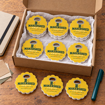 Craft Store custom logo bottle opener magnet - bulk order laid out before packing