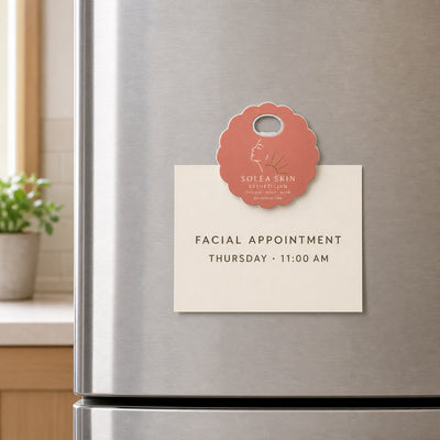 Esthetician custom logo bottle opener magnet - held on a refrigerator door by its magnetic back
