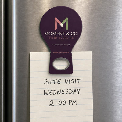 Event Planner custom logo bottle opener magnet - held on a refrigerator door by its magnetic back