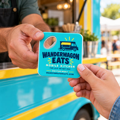 Food Truck Promotional custom logo bottle opener magnet - handed to a customer