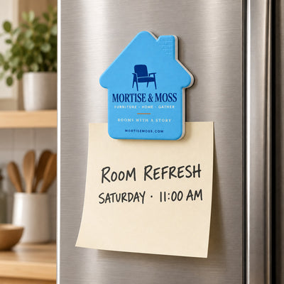 Furniture Store custom logo bottle opener magnet - held on a refrigerator door by its magnetic back