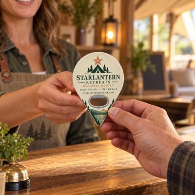 Glamping Resort custom logo bottle opener magnet - handed to a customer
