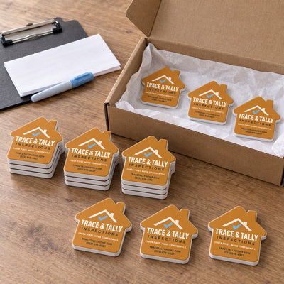 Home Inspector custom logo bottle opener magnet - bulk order laid out before packing