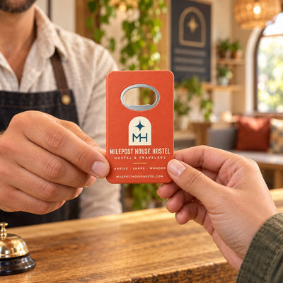 Hostel custom logo bottle opener magnet - handed to a customer