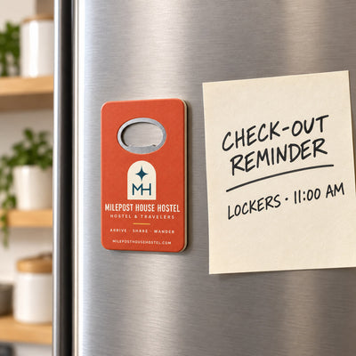 Hostel custom logo bottle opener magnet - held on a refrigerator door by its magnetic back