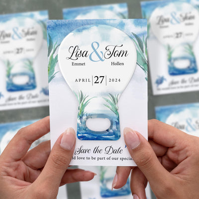 Blue Watercolor Beach save the date bottle opener magnet shown in hand on its printed background card