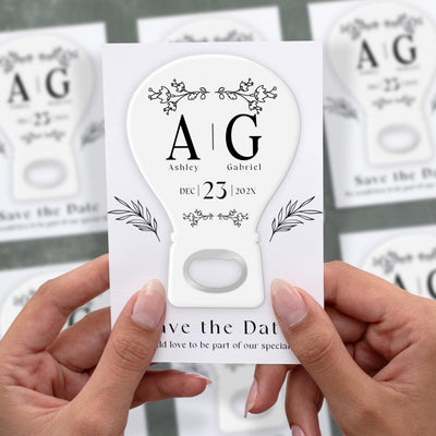 Modern Light Bulb save the date bottle opener magnet shown in hand on its printed background card