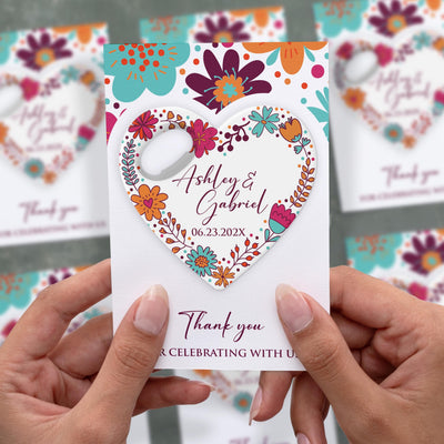 Floral Heart wedding bottle opener magnet shown in hand on its printed background card