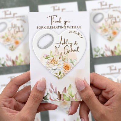 Delicate Floral Heart wedding bottle opener magnet shown in hand on its printed background card