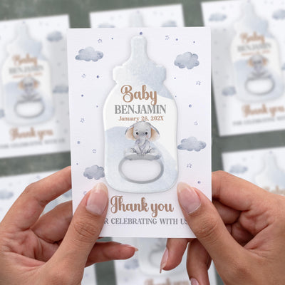 Cloudy Sky baby shower bottle opener magnet shown in hand on its printed background card