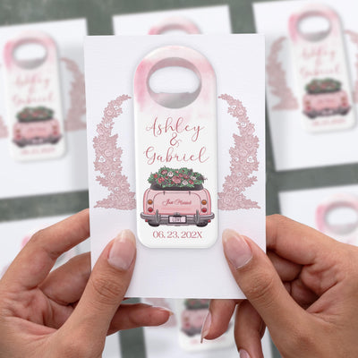 Pink Getaway Car wedding bottle opener magnet shown in hand on its printed background card