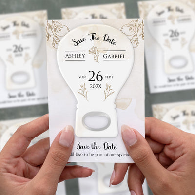 Modern Floral Initials save the date bottle opener magnet shown in hand on its printed background card
