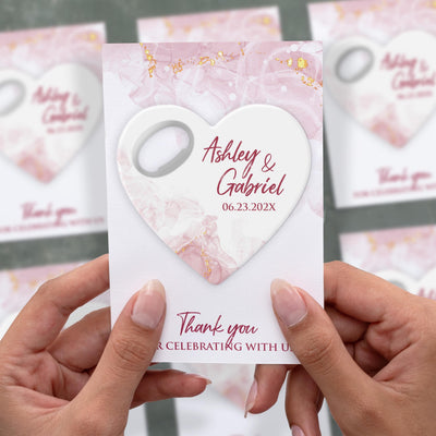 Blush Marble Heart wedding bottle opener magnet shown in hand on its printed background card