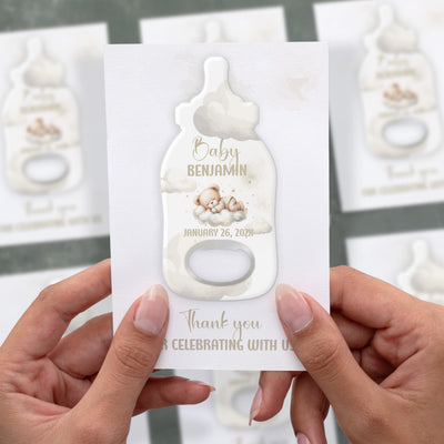 Teddy Bear baby shower bottle opener magnet shown in hand on its printed background card