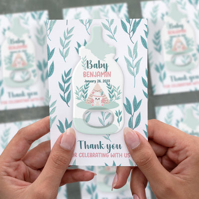 Sage Leaf baby shower bottle opener magnet shown in hand on its printed background card