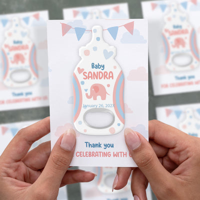 Elephant baby shower bottle opener magnet shown in hand on its printed background card