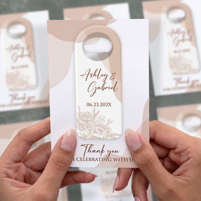 Elegant Floral Names wedding bottle opener magnet shown in hand on its printed background card