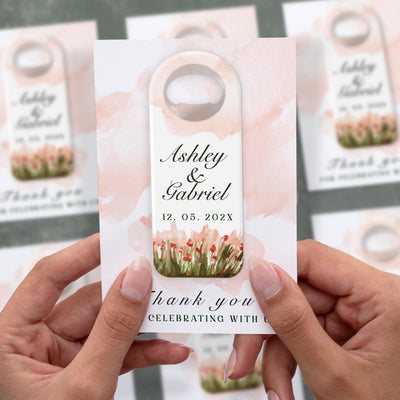 Blush Wildflower Meadow wedding bottle opener magnet shown in hand on its printed background card