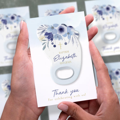 Blue Floral Footprint baptism bottle opener magnet shown in hand on its printed background card