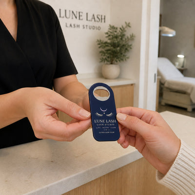 Lash Studio custom logo bottle opener magnet - handed to a customer