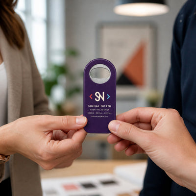 Marketing Agency custom logo bottle opener magnet - handed to a customer