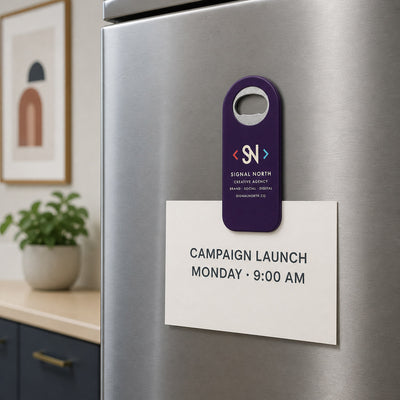 Marketing Agency custom logo bottle opener magnet - held on a refrigerator door by its magnetic back