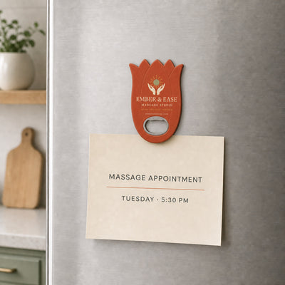 Massage Studio custom logo bottle opener magnet - held on a refrigerator door by its magnetic back