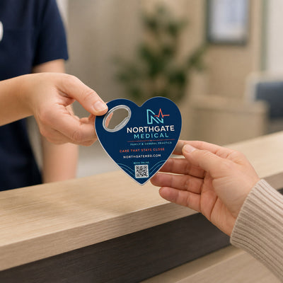 Medical Practice custom logo bottle opener magnet - handed to a customer