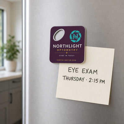 Optometry Practice custom logo bottle opener magnet - held on a refrigerator door by its magnetic back