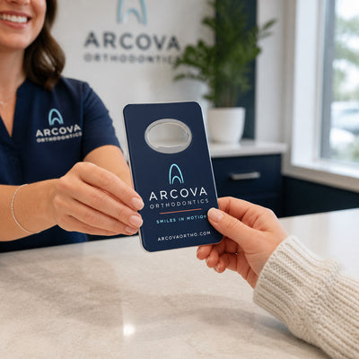 Orthodontic Practice custom logo bottle opener magnet - handed to a customer