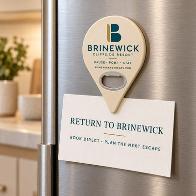 Resort Logo custom logo bottle opener magnet - held on a refrigerator door by its magnetic back