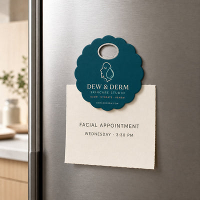 Skincare Studio custom logo bottle opener magnet - held on a refrigerator door by its magnetic back