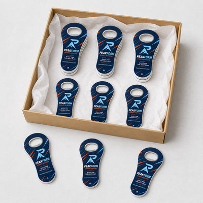 Sports Medicine Clinic custom logo bottle opener magnet - bulk order laid out before packing
