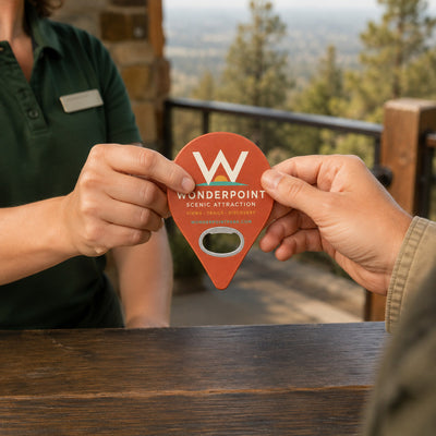 Tourist Attraction custom logo bottle opener magnet - handed to a customer