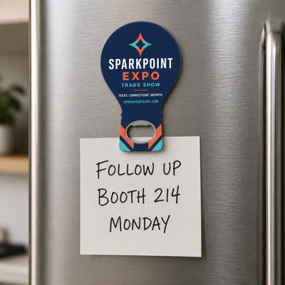 Trade Show Giveaway custom logo bottle opener magnet - held on a refrigerator door by its magnetic back