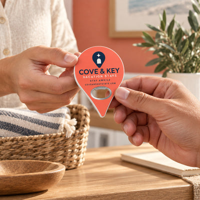 Vacation Rental Welcome custom logo bottle opener magnet - handed to a customer