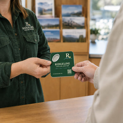 Visitor Center custom logo bottle opener magnet - handed to a customer