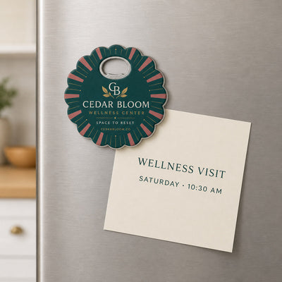Wellness Center custom logo bottle opener magnet - held on a refrigerator door by its magnetic back